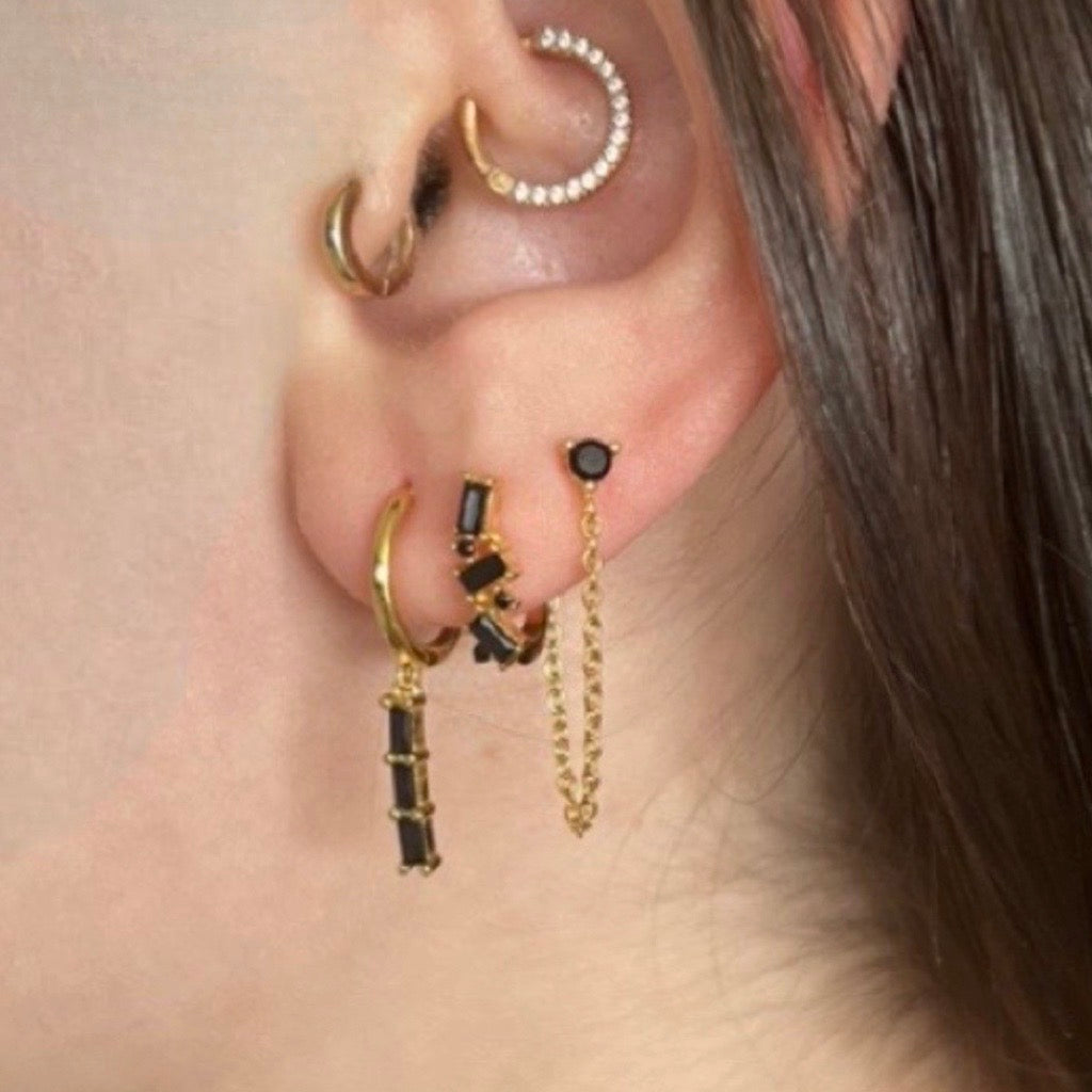 chain drop earrings in black and gold  on models ear with complimentary earrings showing a stack