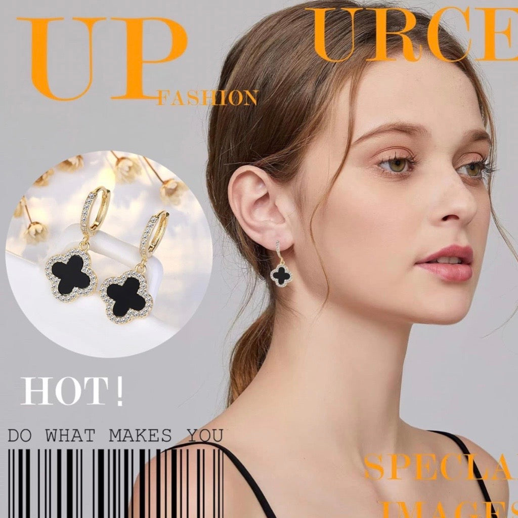 clover earrings in gold and black on magazine cover